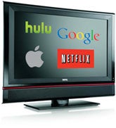 A television displaying logos of streaming and tech companies: Hulu, Google, Apple, and Netflix, representing digital streaming and tech media.