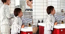 An adult and a child in pajamas stand in a bathroom, with the child using a step stool to reach the sink. The image indicates a morning routine.