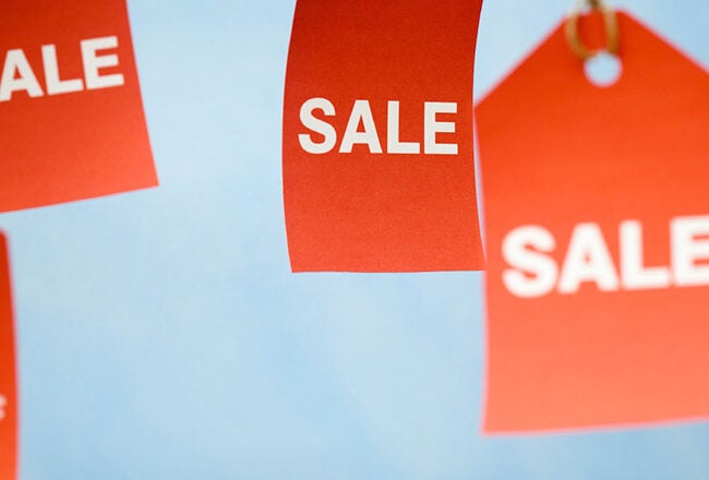 Red sale tags with percentages like "30% off" and "50% off" displayed on a light blue background.