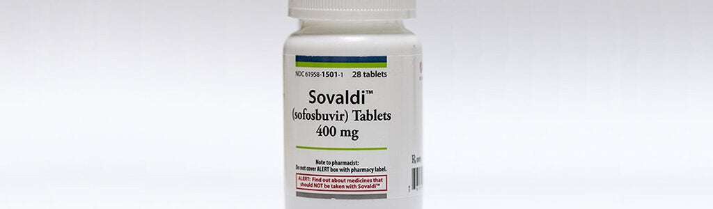 A bottle of Sovaldi (sofosbuvir) tablets, 400 mg, used for treating Hepatitis C. The label includes dosage and warnings.