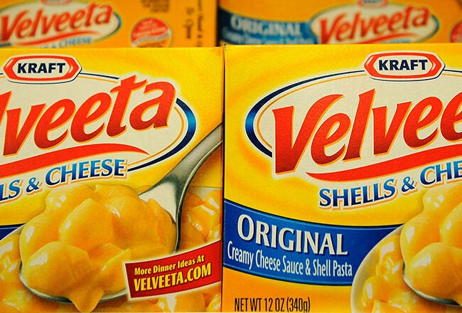 Boxes of Kraft Velveeta Shells & Cheese, displaying the product name and an image of creamy pasta on the packaging.