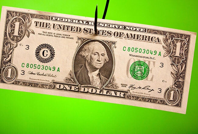 A U.S. one-dollar bill is hanging from a fishhook against a bright green background, symbolizing bait or financial temptation.