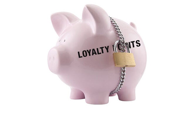 A pink piggy bank with the words "Loyalty Points" printed on it, secured with a chain and padlock, representing the concept of safeguarding loyalty points.