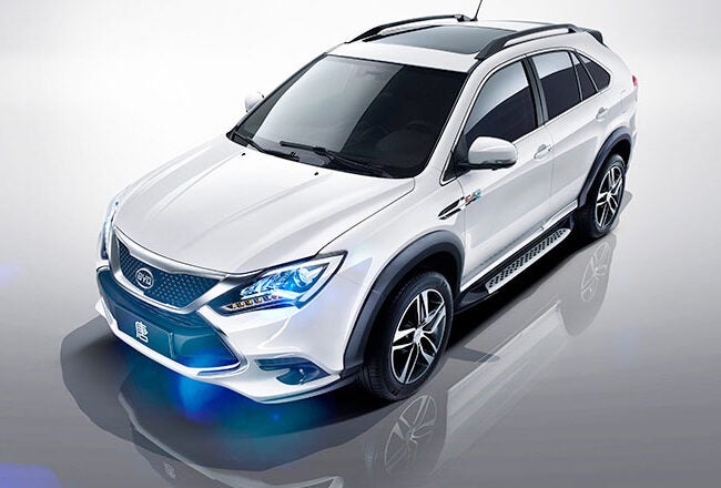 A sleek white SUV with a modern design, featuring tinted windows and alloy wheels, positioned on a reflective surface.