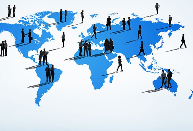 Silhouettes of people standing on a blue world map, representing global community or international connections.
