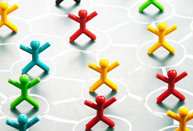 Colorful human-shaped figures are arranged on a board connected by lines, representing a social network or community connection.