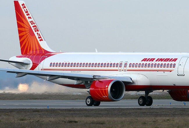 An Air India airplane taxiing on a runway.