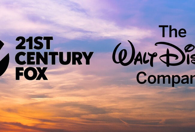 Logos of 21st Century Fox and The Walt Disney Company against a colorful sunset sky, representing corporate branding or partnership.