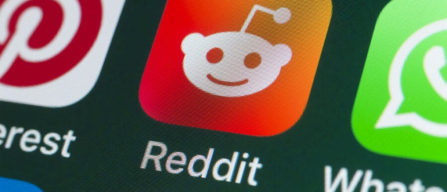 Smartphone screen showing app icons, including Reddit, Pinterest, and WhatsApp.