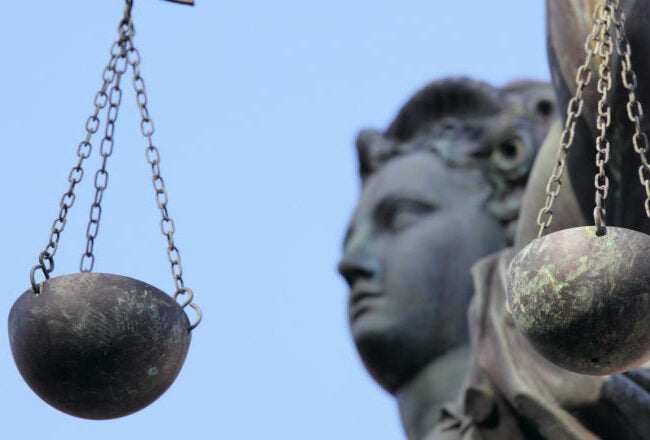 A statue holding traditional scales, symbolizing justice and fairness.