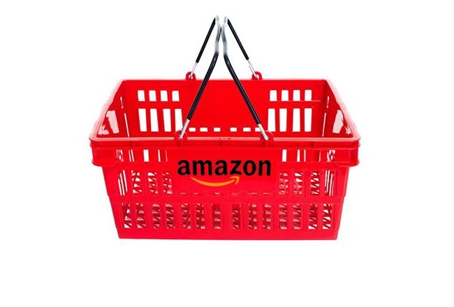 A red shopping basket with the Amazon logo on its side, featuring black handles against a white background.