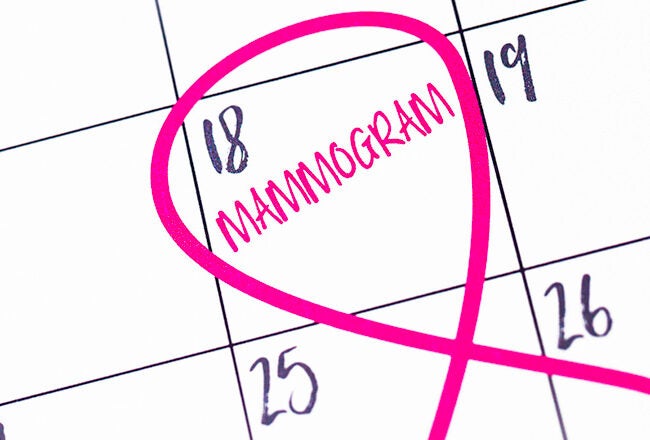 A calendar with the date 18 marked for a mammogram appointment. A pink ribbon symbol surrounds the date, indicating breast cancer awareness.