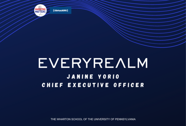 Blue background with wavy lines featuring text: "EVERYREALM" followed by "Janine Yorio, Chief Executive Officer" and "The Wharton School of the University of Pennsylvania." Logos for Marketing Matters and SiriusXM are also present.