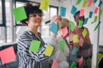 A team of employees brainstorming new ideas using sticky notes