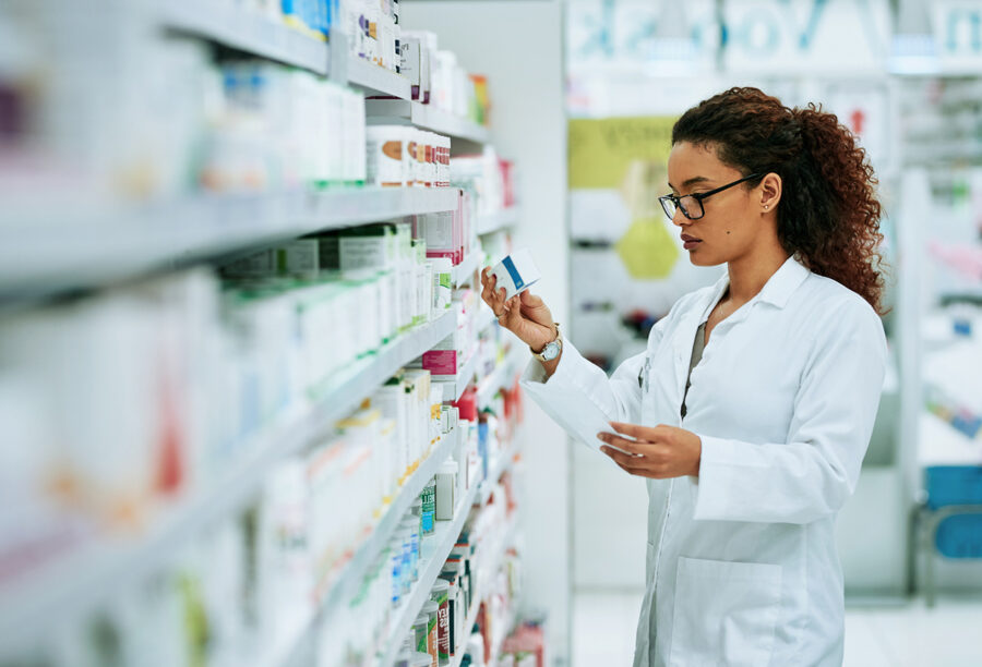 pharmacist checking drug prices at a pharmacy