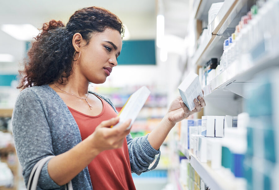 Consumer comparing prices of drugs in the pharmacy to show drug supply chain issues