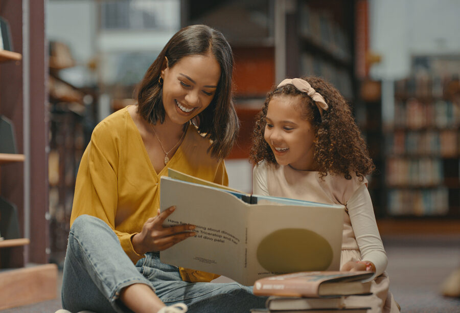 Woman reading a story to a child to show the importance of inclusive storytelling