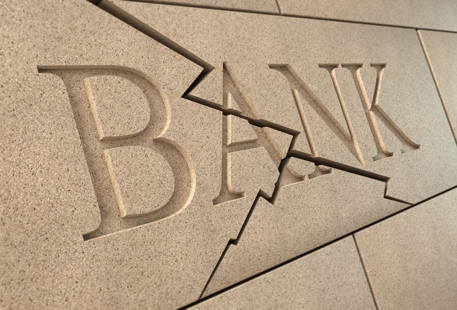 Cracked bank sign signifying the collapse of SVB and the banking crisis