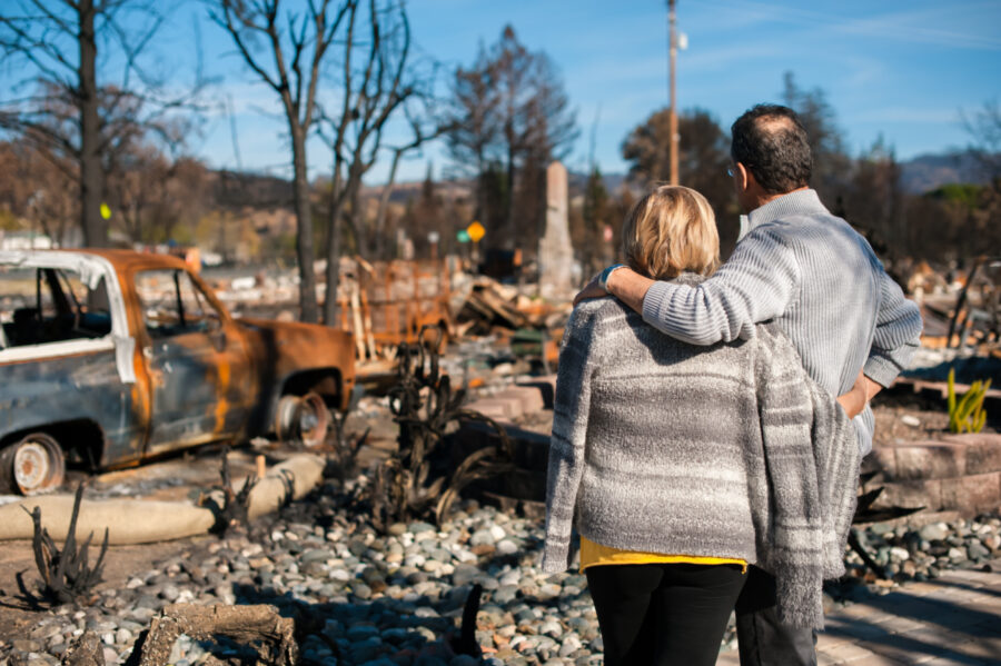 Couple staring at ruins after a fire