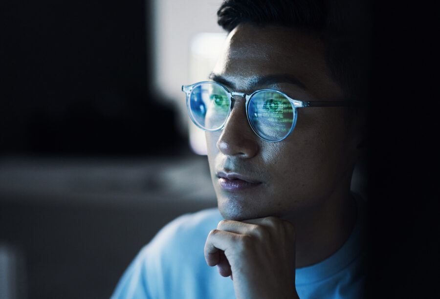 Person looking thoughtfully at a computer screen and strategizing for the future of fintech