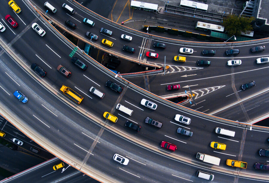 Overhead view of cars on highways to illustrate what causes traffic and congestion in different countries