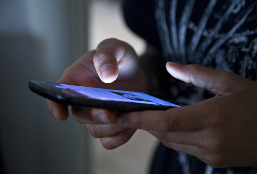 Closeup of someone using a phone to show how Apple's data privacy policies have affected apps