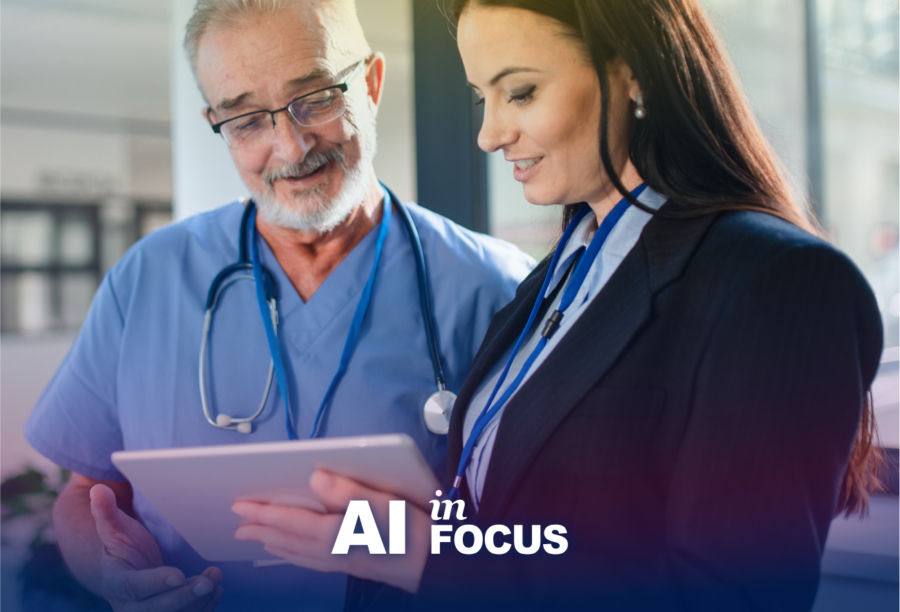 A doctor and businesswoman discussing how AI can improve health care as they look at a tablet with a text overlay that reads "AI in Focus"