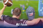 Two men sitting on the couch watching football on TV to show how AI plays a role in sports with a text overlay that reads "AI in Focus"