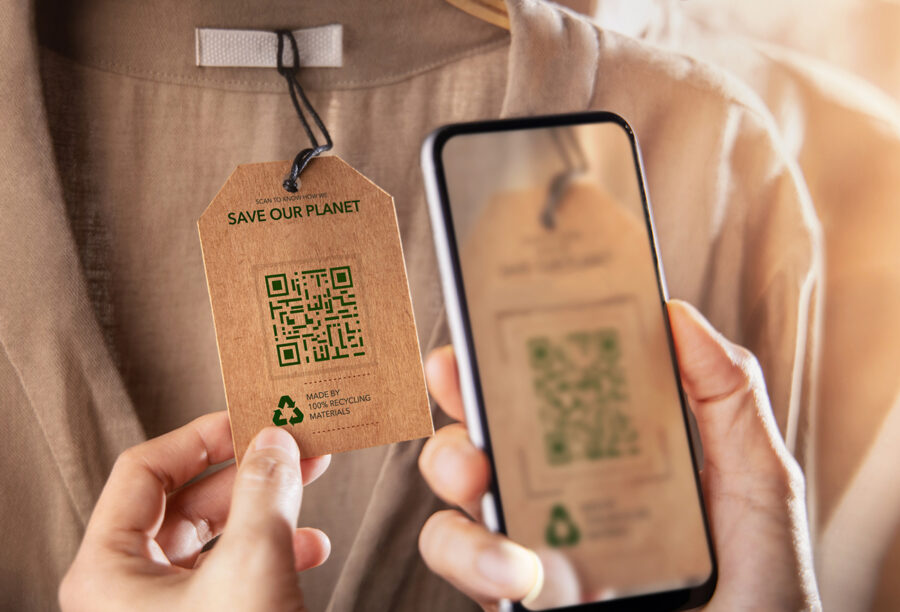 Customer scanning a QR code on clothing tag that reads "Save Our Planet," showing how consumers really do care about ESG