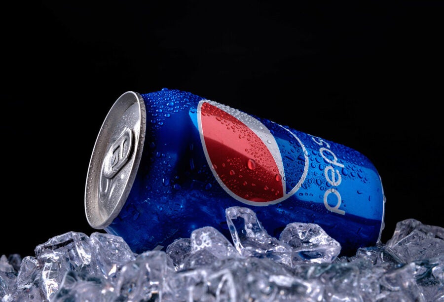 Pepsi soda can resting on a pile of ice