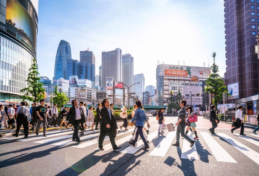 People crossing the street in the Shinjuku shopping district in Tokyo, Japan