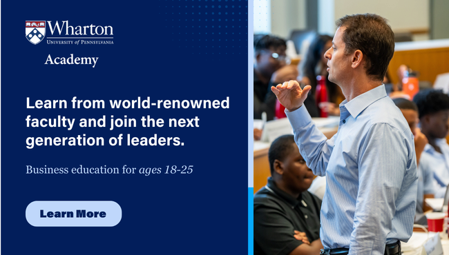 An instructor stands in front of a small group of students in a classroom, gesturing while speaking. The image promotes Wharton Academy's business education program for individuals aged 18-25, emphasizing learning from renowned faculty. Click to learn more.