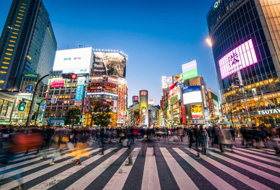 Pedestrians walking across with crowded traffic at Shibuya crossing square. What leadership insights can we learn from Japan?