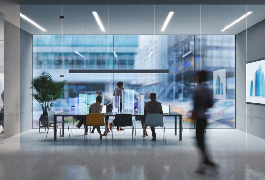 Employees working in a modern office space. What does the workplace look like in 2025?