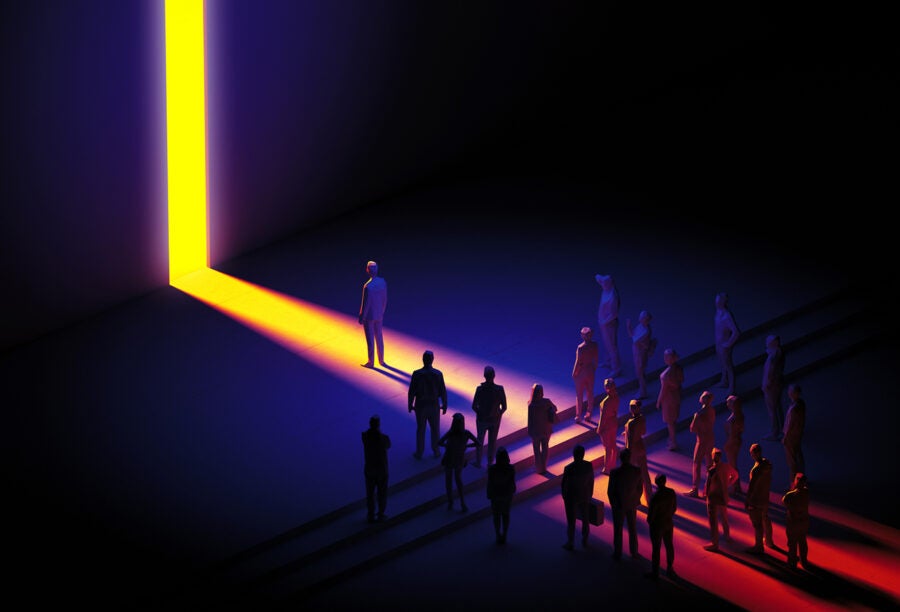 Illustration of a crowd of people gathering toward a strip of light shining through the gap in a wall to show how AI exclusion can impact humankind