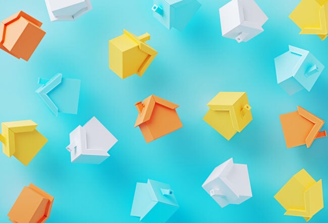 Colorful 3D houses floating in front of a blue background as a representation of the real estate market