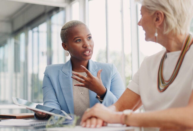 Junior employee speaking with her manager during a work evaluation.