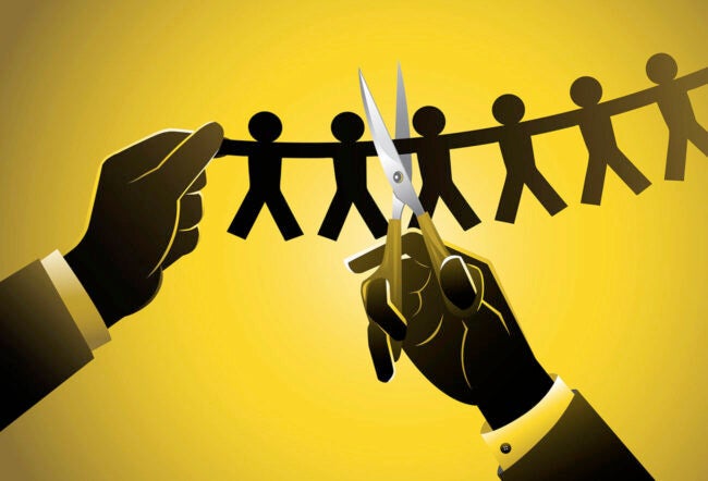 Illustration of a businessman's hands snipping a row of paper people with a pair of scissors. What's causing corporate layoffs?