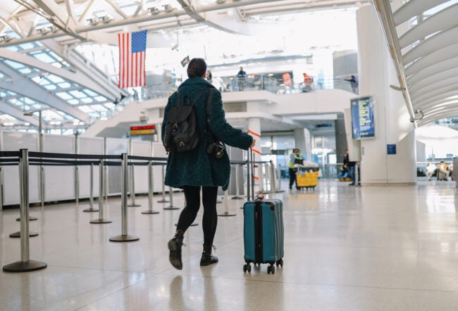 Traveler with a suitcase walking through an American airport