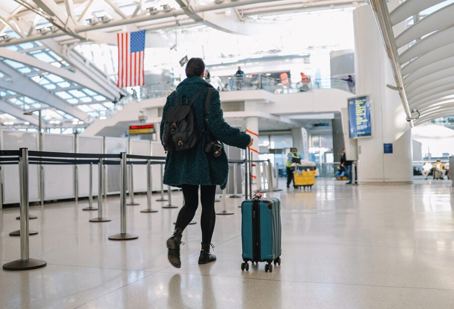 Traveler with a suitcase walking through an American airport