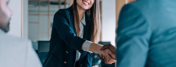 Business woman shaking hands with a business man