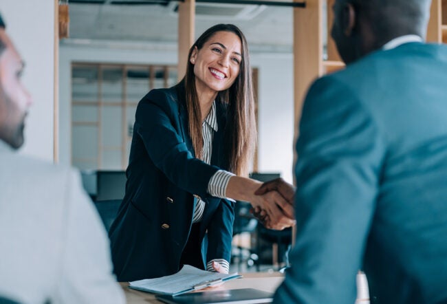 Business woman shaking hands with a business man