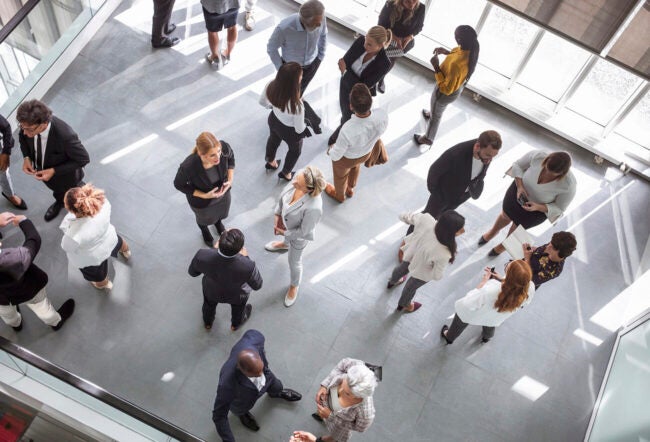 Birds eye view of employees socializing in a room