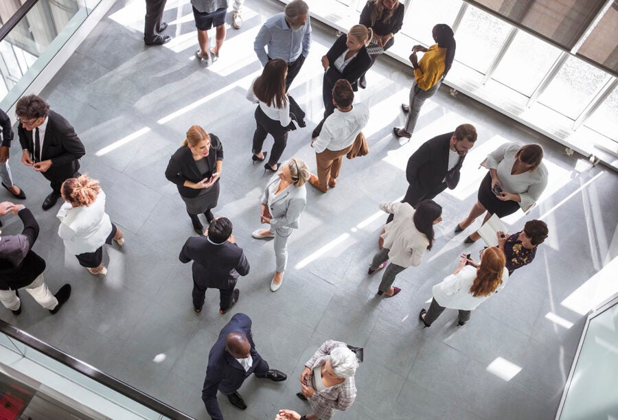 Birds eye view of employees socializing in a room