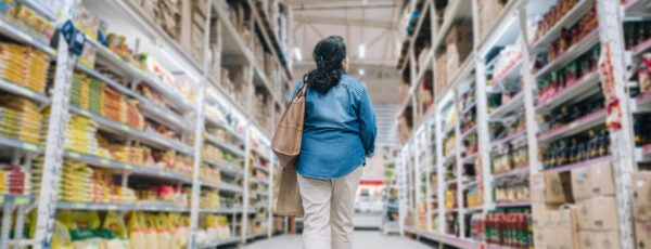 Woman walking down the aisle of a big box store