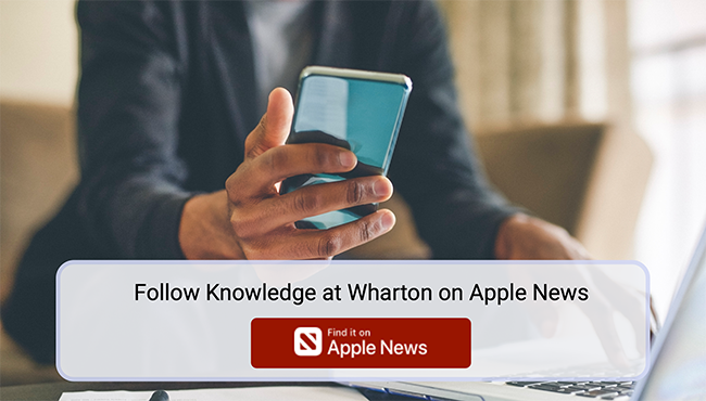 Person using a smartphone to follow Knowledge at Wharton — tap to find and follow Knowledge at Wharton on Apple News for the latest business insights.