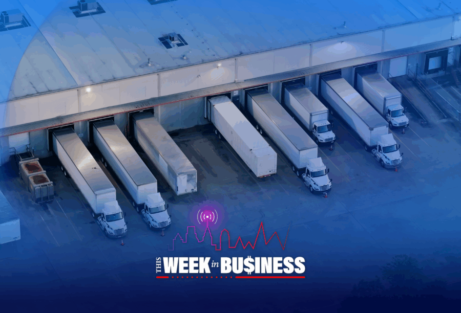 Aerial view of several delivery trucks parked at a loading dock outside a large warehouse, with the words "This Week in Business" overlaid.
