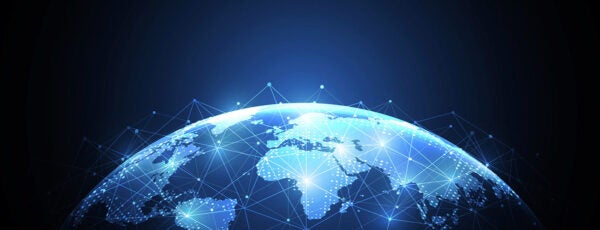 A digital representation of Earth viewed from space, with illuminated network connections spanning across continents, symbolizing global connectivity.