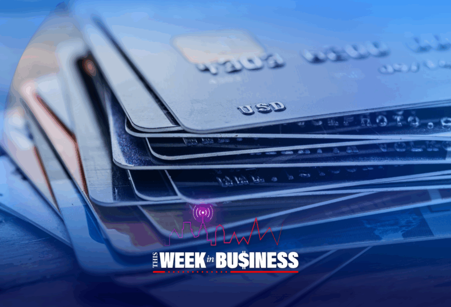 A stack of credit cards with "USD" visible in a corner. Overlay text reads "This Week in Business" with a city skyline, radio signal, and heartbeat line graphics.