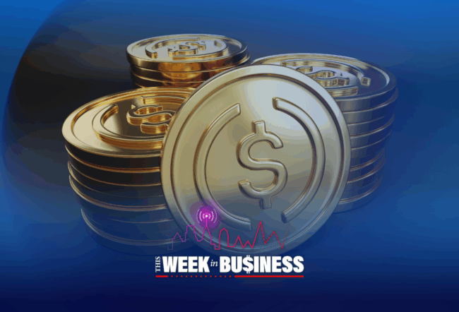 Stacks of gold coins with a dollar sign embossed on each. In the foreground, the text "This Week in Business" with a city skyline and audio wave icon.